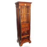 A stained hardwood bookcase, with a gilt flower panel on two black painted plinth columns, with book