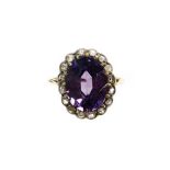 A diamond and alexandrite cluster dress ring, set with oval alexandrite ,surrounded by tiny diamond