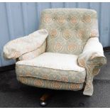 A 1980s/90s retro style swivel chair, upholstered in blue fabric, with pineapple type cream decorati