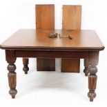 A late Victorian mahogany wind out dining table, the canted top raised on heavily carved reeded tape