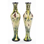 A pair of Moorcroft bud vases, signed E Bossons, in green and cream decoration, limited edition numb