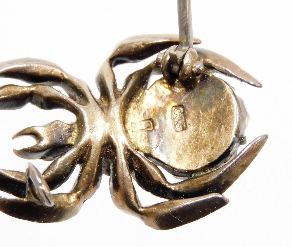 A late Victorian spider brooch, the body set with various paste stones, in a white metal setting, st - Image 2 of 2