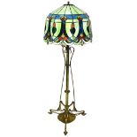 An Art Nouveau brass metamorphic lamp standard, the cylindrical stem held by swan necked supports, o