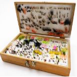 A Bob Church and Co plywood reservoir fly box, and a collection of mainly traditional lures and rese