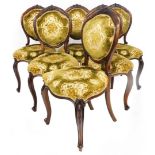 A set of six mahogany framed dining chairs, each with carved floral panel to top on a green and gold