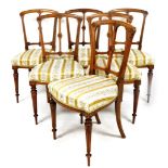 A set of six late 19thC walnut chairs, each with carved single flat back, on floral upholstered seat