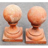 A pair of terracotta domed finials, on rectangular bases, 66cm high, 35cm wide, 35cm deep. (2)