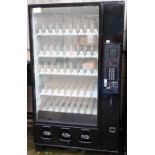 A vending machine, with five rows of nine vending slots, with three grab holes, 185cm high, 107cm wi