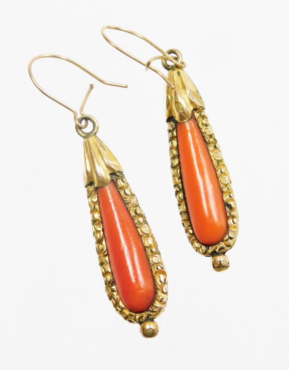 A pair of early to mid 20thC coral drop earrings, each with tear drop shaped coral centre and a gold - Image 2 of 2