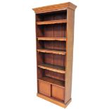 A Victorian mahogany open bookcase, with moulded cornice and adjustable shelves with tassels over a