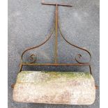 A vintage garden roller, on cast metal frame, with heavy stone roller base, 136cm high, 80cm wide.