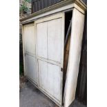 A Victorian painted pine house keeper's cupboard, with moulded cornice top above two sliding doors a