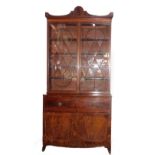 A George III mahogany secretaire bookcase, with a stepped arch pediment with satinwood stringing, fl