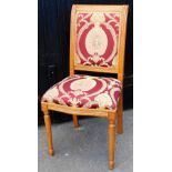 A carved oak hall chair, newly upholstered in a red and gold regal type fabric, on tapered legs, 98c