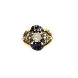 An 18ct gold sapphire and diamond set dress ring, of abstract fan design, with central imitation dia