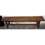An oak bench, 47cm high, 180cm wide, 30cm deep.