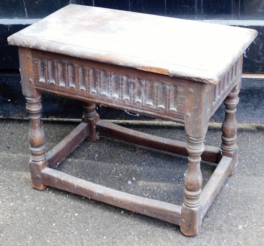 A late 18thC oak joint stool, with moulded top, scoop carved frieze, turned baluster legs and plain