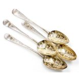 A composite set of four Georgian silver serving spoons, each heavily decorated with scrolls and flow