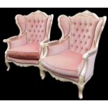 A pair of French style bedroom chairs, each with cream painted frames, on a pink draylon button back