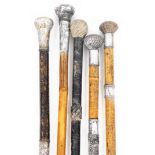 A group of Eastern style walking canes, each with silver plated tap ends, of varying sizes. (5)