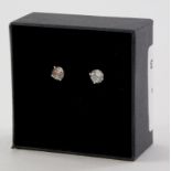 A pair of 18ct white gold diamond stud earrings, each with round brilliant cut stone, in four claw s