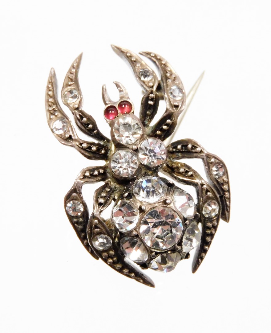 A late Victorian spider brooch, the body set with various paste stones, in a white metal setting, st