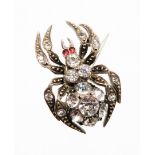 A late Victorian spider brooch, the body set with various paste stones, in a white metal setting, st