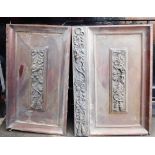 A pair of 19thC carved mahogany doors, embellished with ribbons, flowers and cherubs, 103cm high, 14