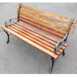 A garden bench, with stained wooden slats, and metal ends, 120cm wide, 48cm deep.