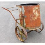 A vintage galvanised water butt, on a wheel barrow type metal frame, 87cm high, 132cm wide.