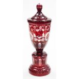 A Bohemian coloured glass goblet and lid, in red flash glass with swirls and flowers detailing, 40cm
