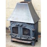 A metal log burning stove, with turret top, 91cm high, 60cm wide.