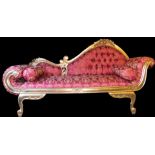 A Victorian style gold chaise longue, overstuffed to the back and seat in urn and garland material o