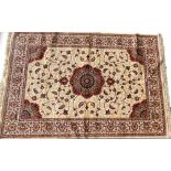 A gold ground cashmere rug, with floral medallion, 170cm x 120cm.