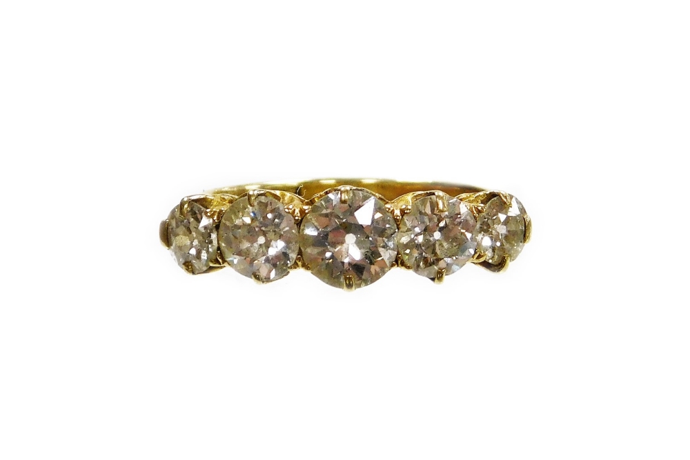 A Victorian diamond five stone dress ring, set with five round brilliant cut diamonds, the central s