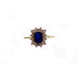 A sapphire and diamond cluster ring, with central rectangular cut sapphire totally 0.86cts, surround