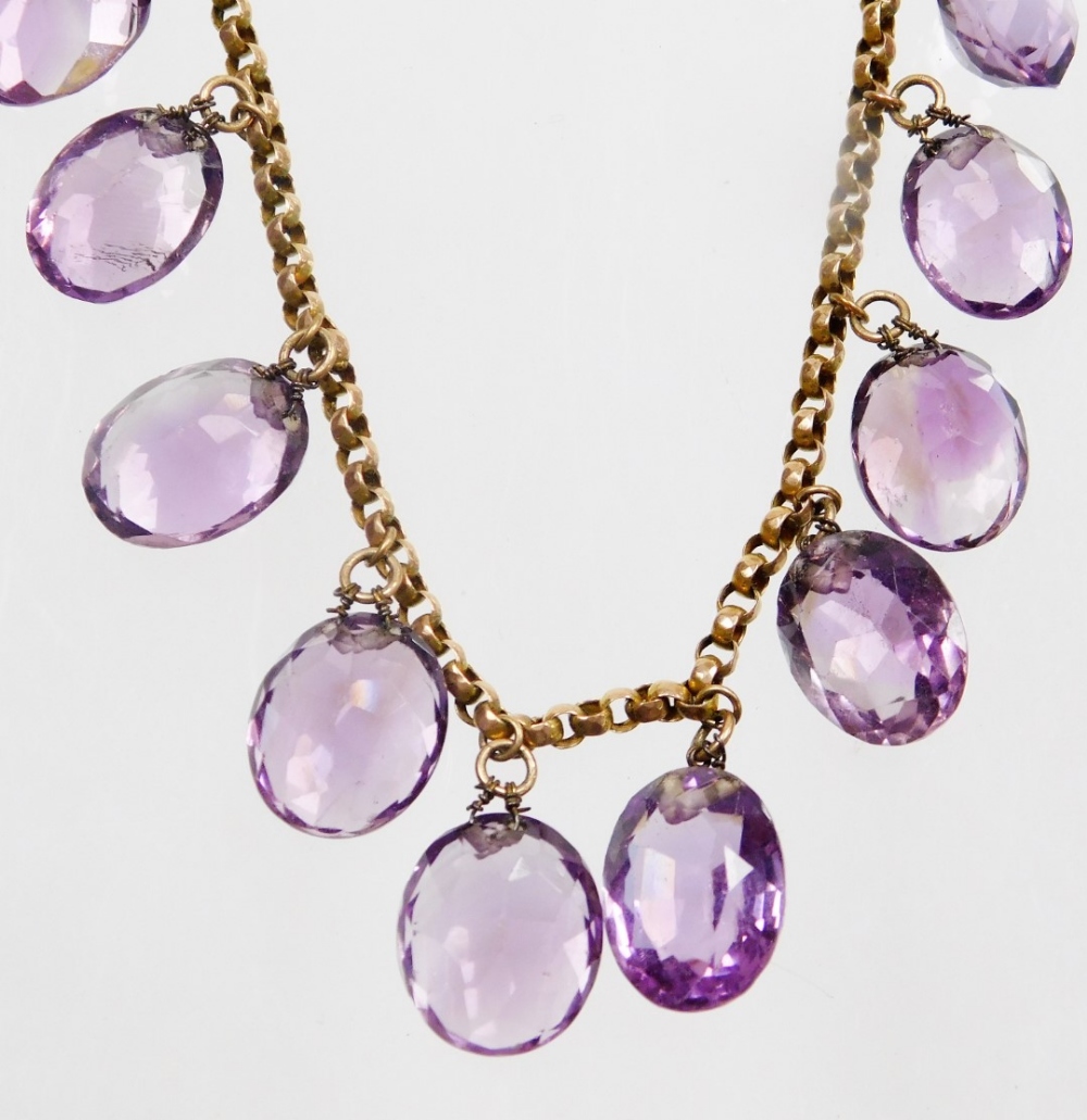 An Edwardian design amethyst graduated beaded necklace, set with twenty two oval cut amethysts, on a - Image 2 of 3