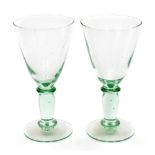 Two early 19thC glass goblets, each with a domed stem foot, and flared rim, 20cm high, 10cm diameter