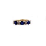 A sapphire and diamond dress ring, set with three round brilliant cut sapphires totalling approximat