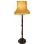 An oak standard lamp, on turned column with gold shade, 162cm high.