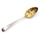 A George III silver berry spoon, with silver gilt repousse bowl and engraved Old English pattern han