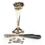 An Edwardian silver specimen vase, trumpet flared with shaped floral rim and stepped weighted base,