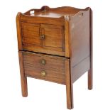 A George III mahogany night commode, with galleried top, pierced handles, front pot cupboard and tw