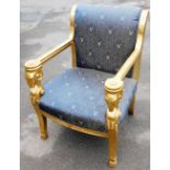 A French style throne chair, with gilt painted ram's head arms and hoof feet, with acanthus leaf dec