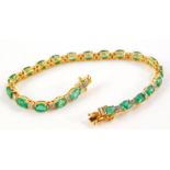 An 18ct gold emerald and diamond bracelet, set with various oval emeralds totalling approx 9.35cts o