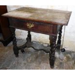 A 17thC oak side table, with overhanging top, frieze drawer and barley twist legs, with a platform s