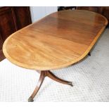 A Georgian style mahogany and yew wood cross banded oval twin pedestal dining table, with one additi