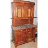 A carved oak kitchen dresser, the dresser top with two astragal glazed doors with engraved fruits of