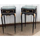 A pair of French style black and gold painted bedside cabinets, each with glass inset top, and silve
