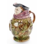 A late 19thC sarreguemines majolica character jug, depicting friar in mottled decoration with a blu